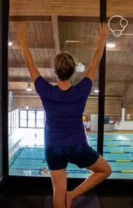 Kay doing yoga in front of the pool