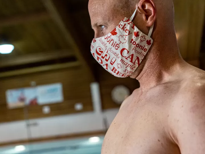 man at a pool with face mask