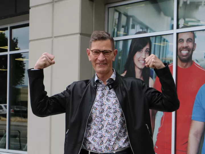 man in leather jacket flexing arms