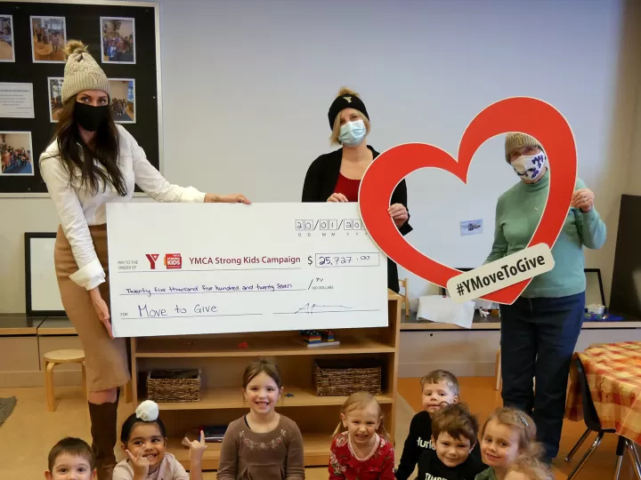 3 women holding up a cheque with children