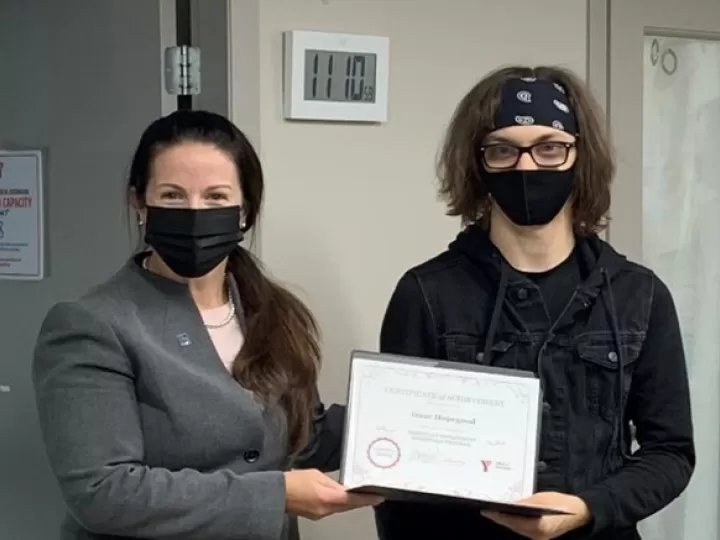 Two people holding up a certificate