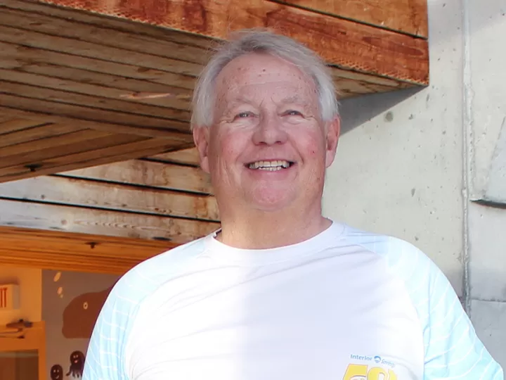 Man smiling by a pool